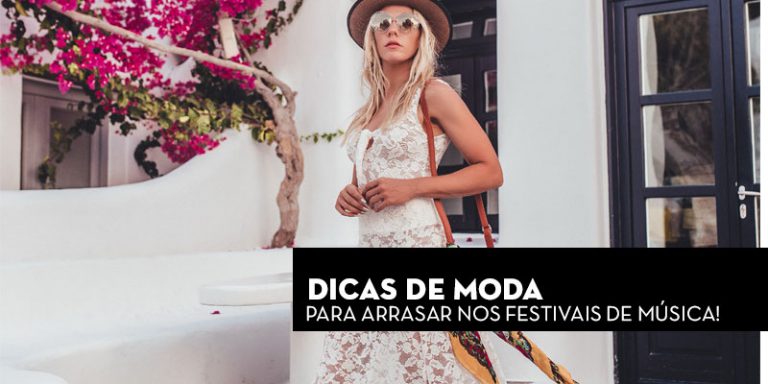 Mulher usando vestido branco com detalhes em renda, chapéu e óculos escuros, em ambiente ao ar livre.