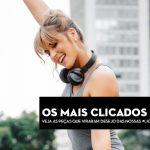Mulher com fones de ouvido e blusa de ginástica, sorrindo em ambiente urbano.
