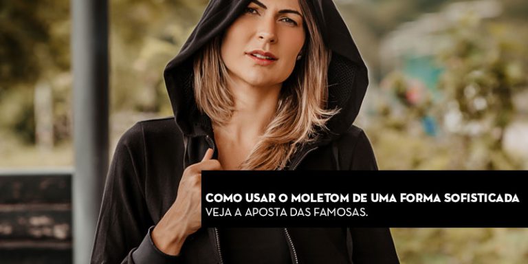 Mulher com moletom preto em ambiente ao ar livre, texto sobre uso sofisticado do moletom.