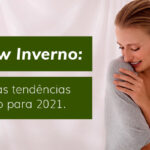 Mulher sorrindo com blusa cinza, destacando tendências de inverno 2021. Texto: "Preview Inverno: conheça as tendências de inverno para 2021.