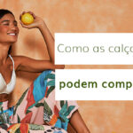 Mulher sorrindo com calças de praia estampadas e blusa branca, segurando um limão.