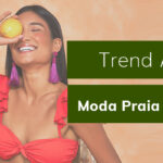 Mulher sorrindo com biquíni vermelho, segurando limão, ao lado de texto 'Trend Alert' e 'Moda Praia Verão 22'.